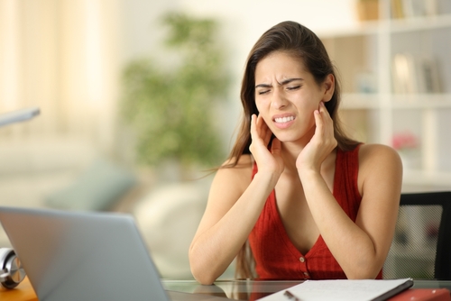 woman suffering from jaw pain