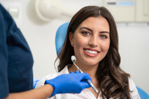 woman smiling during dental cleaning