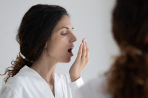woman smelling her breath
