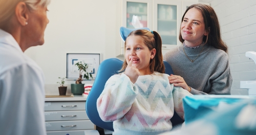 Child,,Dentist,And,Show,Tooth,At,Dental,Consultation,With,Orthodontist