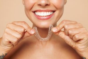 woman holding invisalign tray